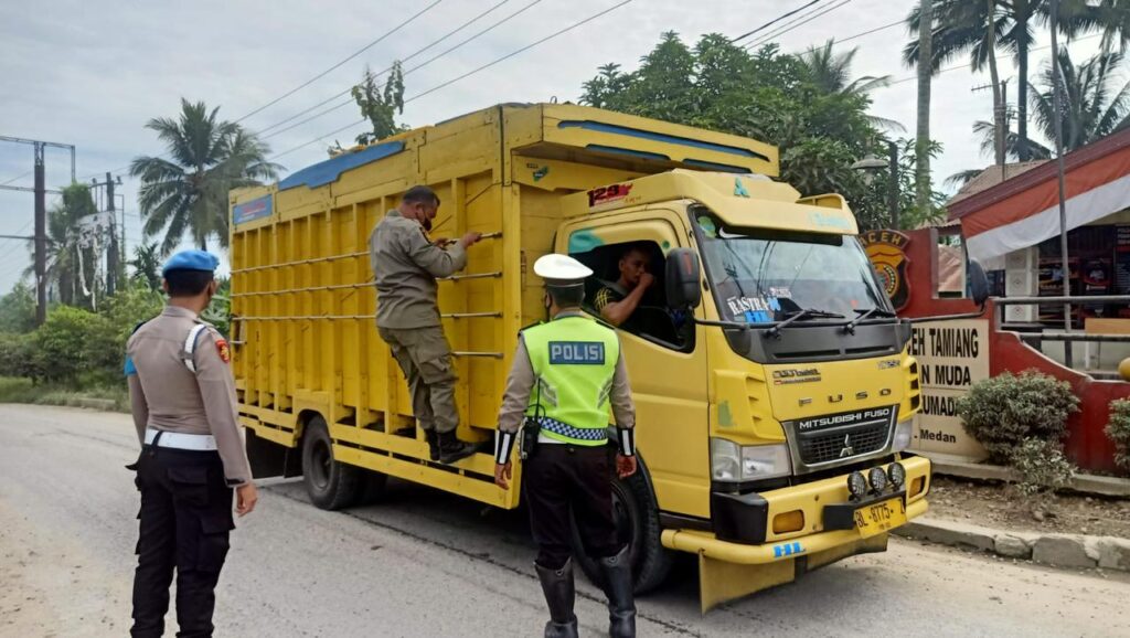 Petugas gabungan menggelar razia dengan menyetop dan memeriksa muatan kendaraan yang melintas di Pos Sekat perbatasan Sumut-Aceh Jalinsum, Kecamatan Besitang, Kabupaten Langkat.