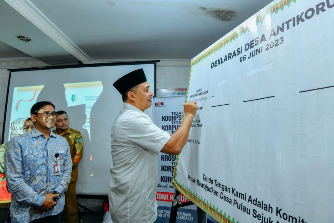 Bupati Batubara Ir H Zahir MAP beserta seluruh peserta melakukan tanda tangan sebagai bentuk komitmen bersama dalam mewujudkan Desa Pulau Sejuk sebagai desa anti korupsi, Selasa (6/6/2023). (Dok/Kominfo Batubara)