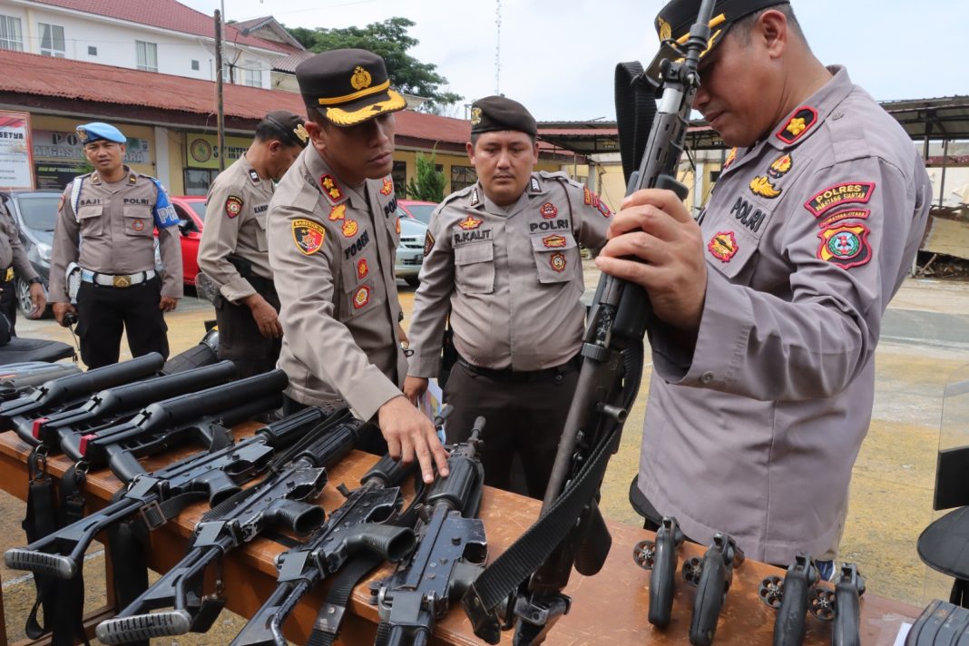 Kapolres Pematangsiantar AKBP Yogen Heroes Baruno memeriksa sejumlah senjata kepemilikan personel di Lapangan Apel Mapolres Pematangsiantar, Jumat (18/8/2023). (Dok/Humas Polres Pematangsiantar)