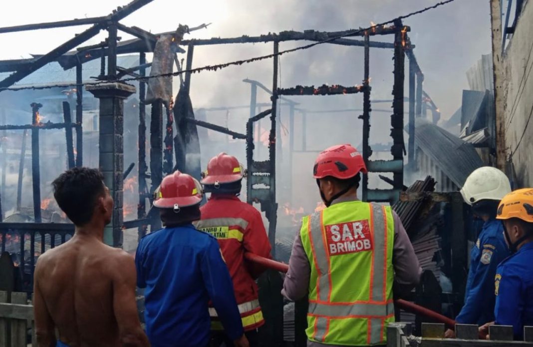 Tim Respons Bencana Batalyon A Pelopor Sat Brimob Polda Kaltim bersama warga ikut membantu padamkan api kebakaran yang terjadi di Sepinggan Baru.