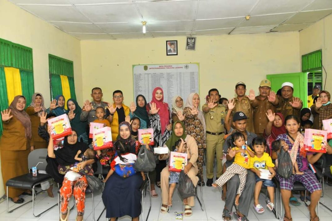 Wakil Bupati Labura H Samsul Tanjung dan lainnya foto bersama siswa di acara pemberian makanan tambahan kepada siswa di Puskesmas Tanjung Leidong, Senin (28/8/2023). (Dok/Kominfo Labura)