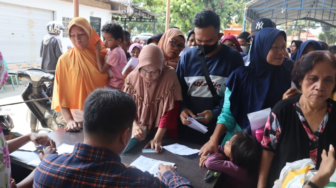 Terlihat warga sedang mengantri untuk mendapatkan bantuan cadangan beras tahap 2 termin II dari Bapanas, di halaman Kantor Pos Kota Tebingtinggi, Jalan Sutomo, Jumat (6/10/2023). (Dok/Kominfo Tebingtinggi)