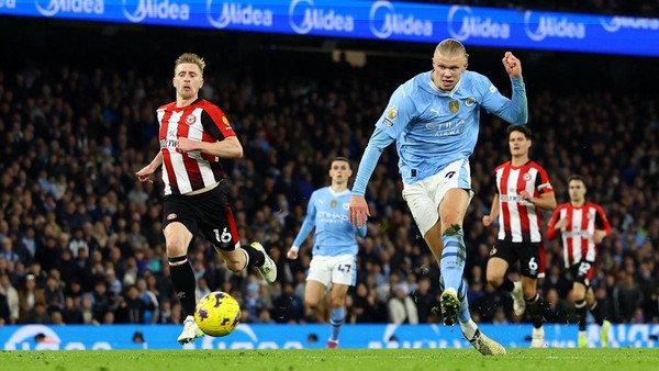 Striker Manchester City Erling Haaland menembak dan mencetak gol pertama timnya pada pertandingan Liga Inggris antara Man City vs Brentford di Stadion Etihad di Manchester, Inggris, pada 20 Februari 2024.