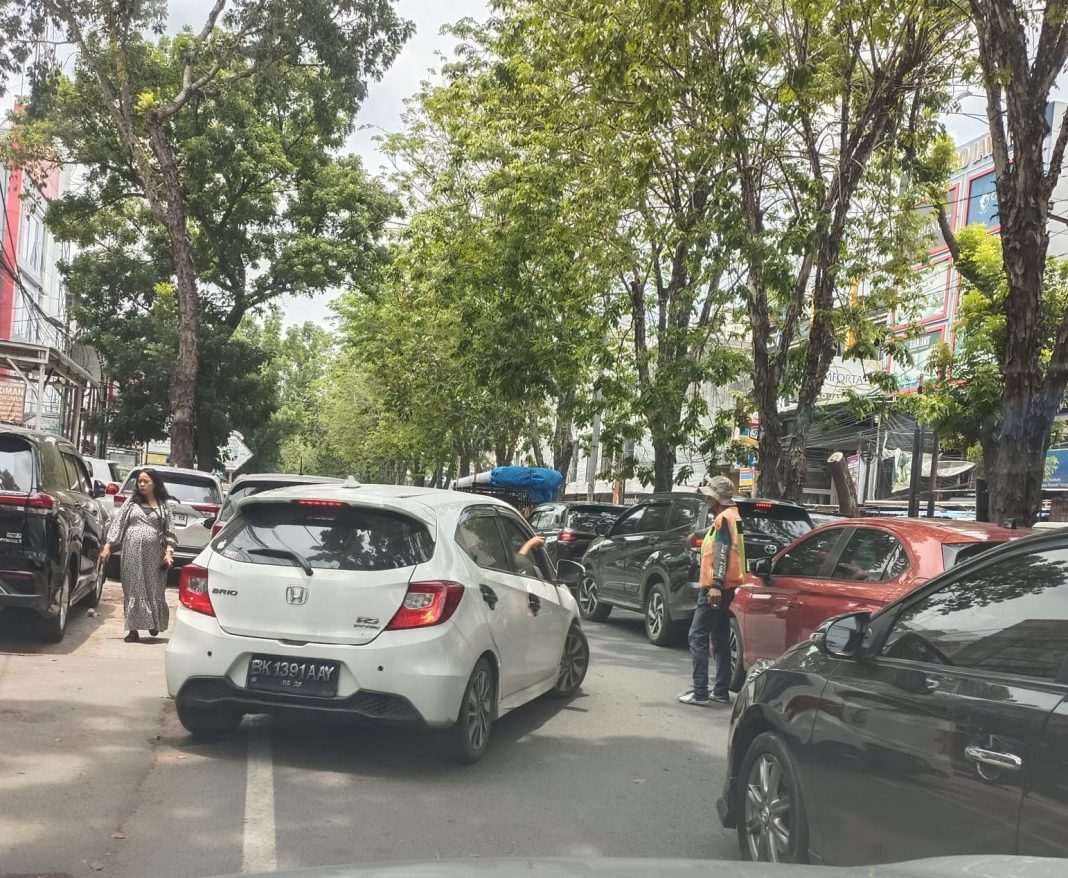 Petugas parkir masih meminta uang parkir di depan Apotik Penang, Jalan Setia Budi Medan, Sabtu (5/4/2024).