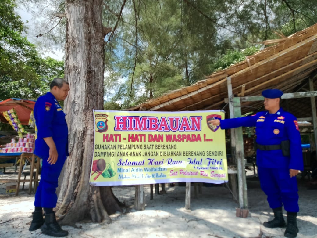 Personel Satpol Airud Polres Sergai memasang spanduk imbauan Kamtibmas di lokasi objek wisata pantai di Kecamatan Pantai Cermin, Kamis (11/4/2024). (Dok/Humas Polres Sergai)