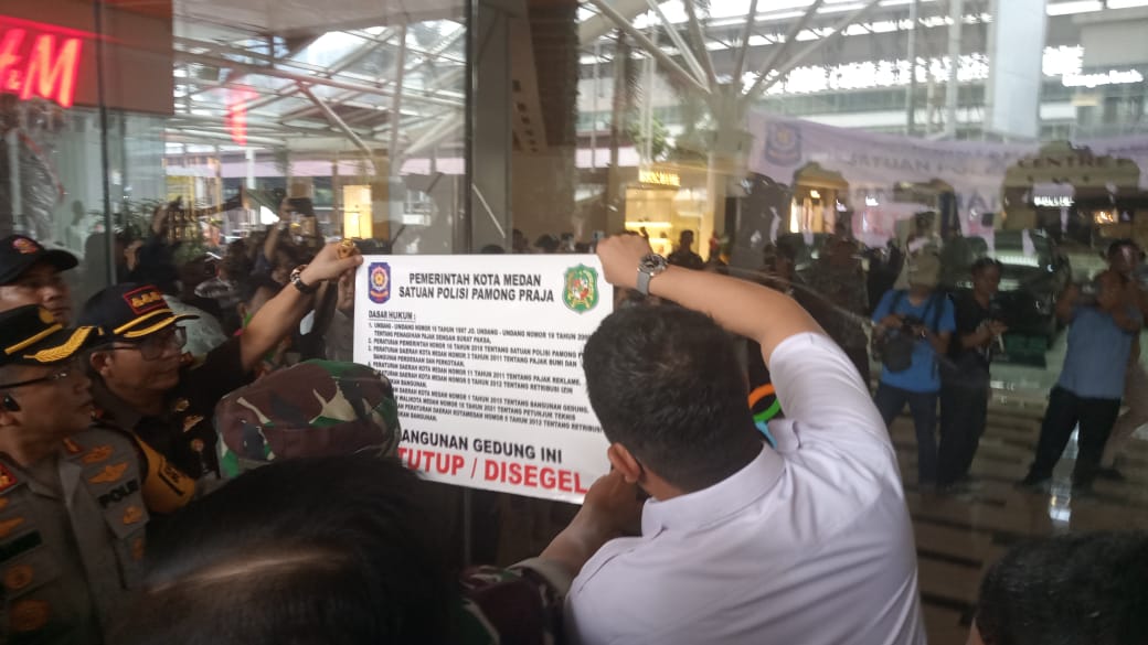 Wali Kota Medan Bobby Nasution menempel stiker segel di pintu masuk gedung Mall Centre Poin di Jalan Jawa, Kelurahan Gang Buntu, Kecamatan Medan Timur, Rabu (15/5/2024).