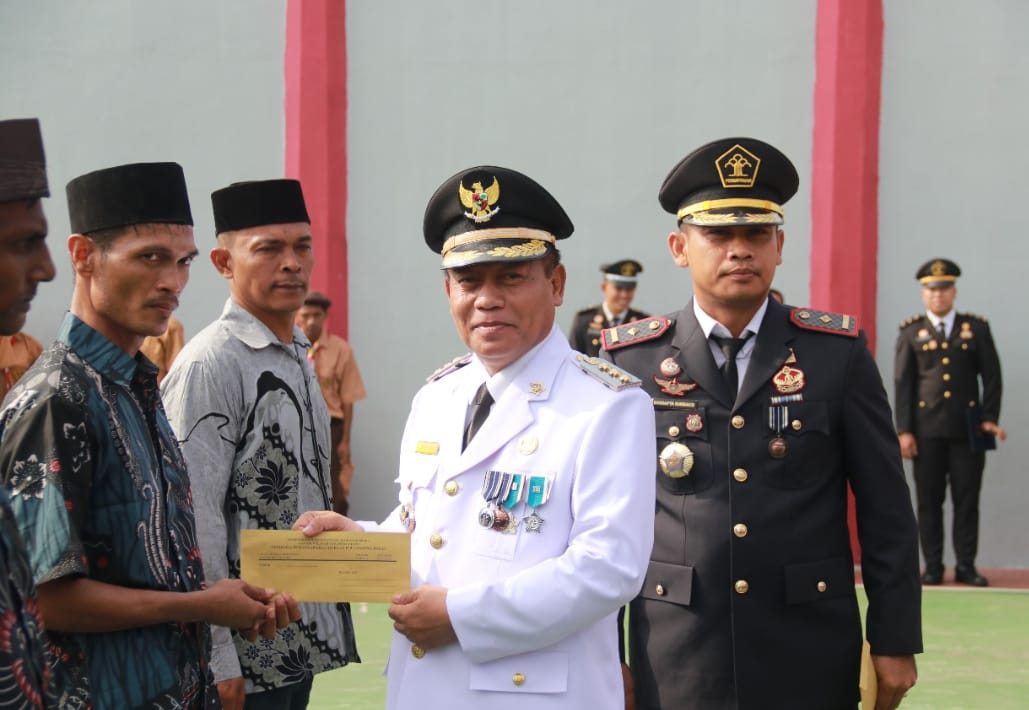 Wali Kota Tanjungbalai Dr H Waris Tholib SAg MM didampingi Kepala Lapas Kelas IIB Tanjungbalai Asahan Sangapta Surbakti saat memberikan surat bebas kepada 13 warga binaan di Lapangan Lapas Tanjungbalai Asahan, Sabtu (17/8/2024). (Dok/Humas Lapas)