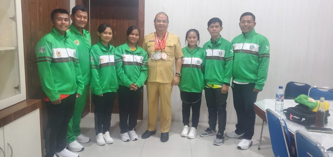 Kepala Pelatda Gateball, Jhonson Roy Hutapea dan lainnya serta para atlet foto bersama tunjukkan medali usai PON XXI baru-baru ini di Medan.