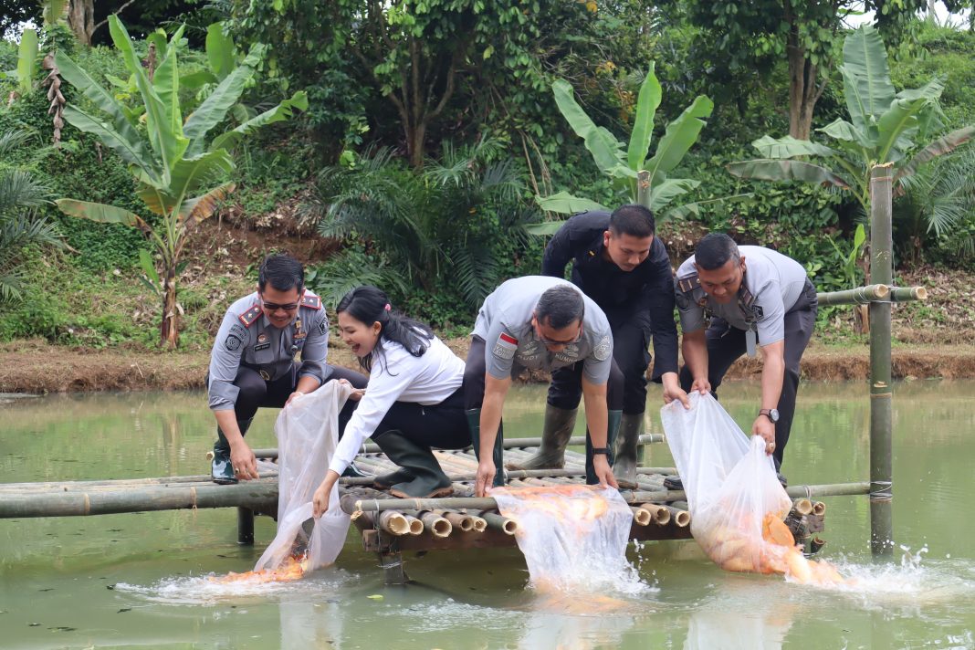 Kepala Divisi Pemasyarakatan Kanwil Kemenkumham Sumut Rudy Fernando Sianturi bersama Kepala Lapas Pancurbatu Nimrot Sihotang menabur benih ikan mas sebagai bagian dari program ketahanan pangan di Desa Marindal I.