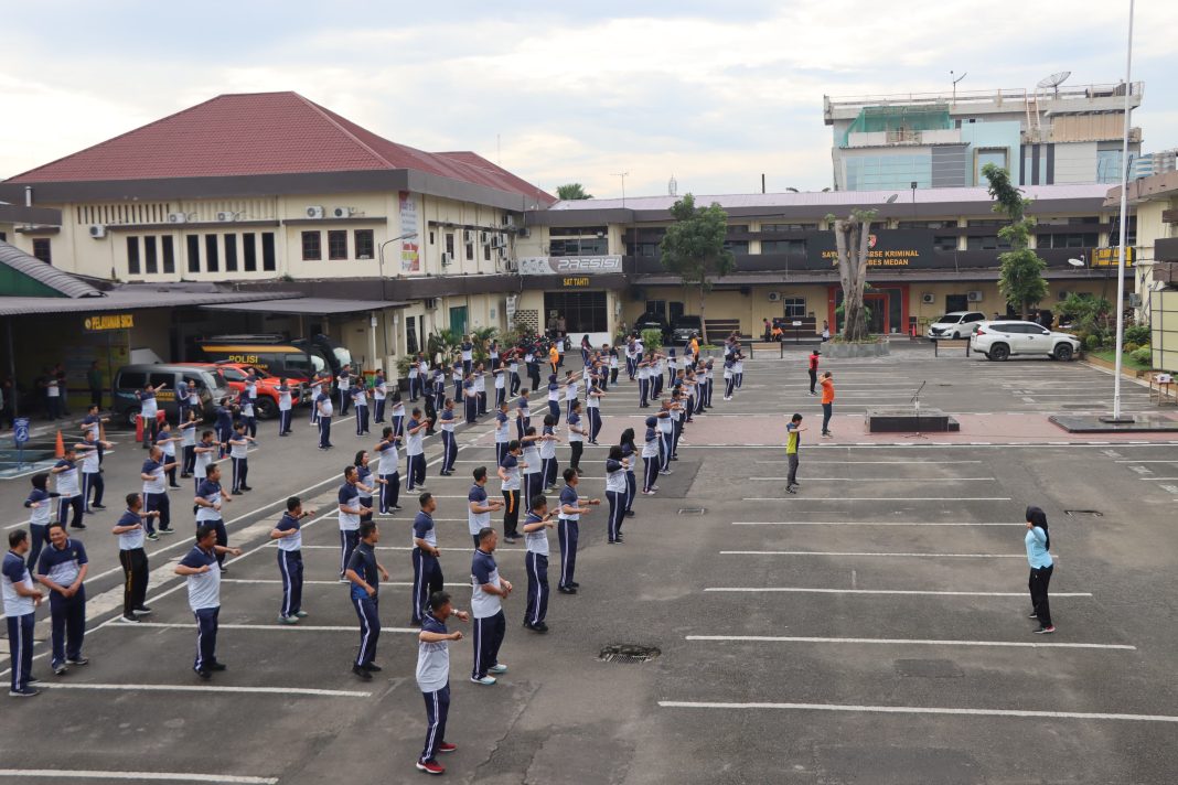 Instruktur memandu senam aerobik bersama personel Polrestabes Medan dalam kegiatan olahraga pagi, Sabtu (25/1/2025).