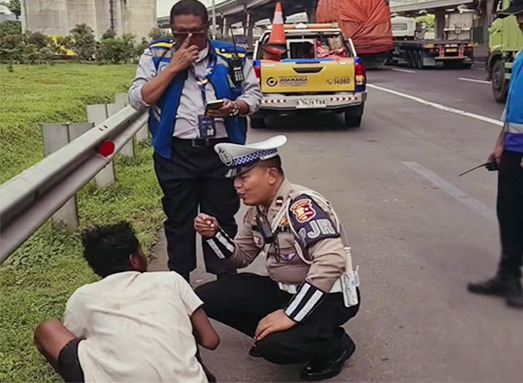 Anggota PJR Cikampek memberikan bantuan kepada seorang pria diduga ODGJ yang ditemukan di tepi Tol Jakarta-Cikampek agar terhindar dari kecelakaan.